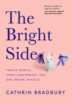 Book cover, The Bright Side by Cathrin Bradbury - light salmon coloured with a small rabbit figurine with pom-poms.